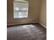 Bright bedroom with a window and plush carpeting at 417 Victoria Hills Dr, Deland, FL 32724