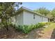 A home's exterior features garden beds and large window accents at 417 Victoria Hills Dr, Deland, FL 32724