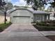 Charming home featuring a paver driveway and a well-maintained front lawn at 417 Victoria Hills Dr, Deland, FL 32724