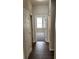 Inviting hallway with wood floors leading to a room with natural light from the window at 417 Victoria Hills Dr, Deland, FL 32724