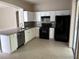 Spacious kitchen featuring white cabinets, granite countertops, and stainless steel appliances at 417 Victoria Hills Dr, Deland, FL 32724