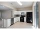Modern kitchen with white cabinets, stainless steel dishwasher, granite countertops and black appliances at 417 Victoria Hills Dr, Deland, FL 32724