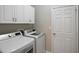 Convenient laundry room with upper cabinets and modern washer and dryer at 417 Victoria Hills Dr, Deland, FL 32724
