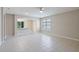 Open-concept living area with tile flooring, a ceiling fan, and access to other rooms in the home at 417 Victoria Hills Dr, Deland, FL 32724