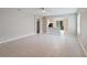 Open-concept living room with tile flooring leading to the kitchen and outdoor views at 417 Victoria Hills Dr, Deland, FL 32724