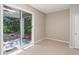 Bright sunroom featuring neutral walls, tile flooring, and access to an outdoor patio at 417 Victoria Hills Dr, Deland, FL 32724