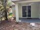 Covered patio area with a sliding glass door and a view of the backyard at 417 Victoria Hills Dr, Deland, FL 32724