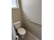Small powder room with toilet, neutral tile and a grab bar for accessibility at 417 Victoria Hills Dr, Deland, FL 32724
