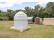 Backyard with various outbuildings and a unique observatory dome for stargazing enthusiasts at 441 E Kicklighter Rd, Lake Helen, FL 32744