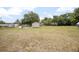 Large, grassy backyard with sheds and plenty of room to enjoy outdoor activities on the property at 441 E Kicklighter Rd, Lake Helen, FL 32744