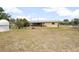View of the backyard, home, and covered porch at 441 E Kicklighter Rd, Lake Helen, FL 32744