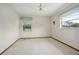 Bright bedroom with neutral carpet, ceiling fan, and multiple windows at 441 E Kicklighter Rd, Lake Helen, FL 32744