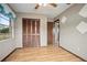 Bedroom view showcasing a ceiling fan, closet, and wood-look flooring at 441 E Kicklighter Rd, Lake Helen, FL 32744