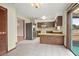 Bright kitchen with tile flooring, ample cabinetry, and stainless steel refrigerator at 441 E Kicklighter Rd, Lake Helen, FL 32744