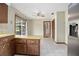 Eat-in kitchen features tile flooring, a modern refrigerator, and plenty of counter space at 441 E Kicklighter Rd, Lake Helen, FL 32744
