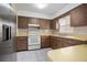Well-lit kitchen featuring tile flooring, updated appliances, and plenty of cabinet space at 441 E Kicklighter Rd, Lake Helen, FL 32744