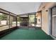 Enclosed porch with green carpet and views of the backyard at 441 E Kicklighter Rd, Lake Helen, FL 32744