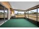 Enclosed porch with green carpet and views of the backyard at 441 E Kicklighter Rd, Lake Helen, FL 32744