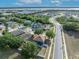 Captivating aerial view of a residential neighborhood near a lake, featuring lush greenery and paved roads at 486 Sycamore Springs St, Debary, FL 32713