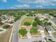 Expansive aerial view of a residential area with mature trees, well-maintained homes, and community green spaces at 486 Sycamore Springs St, Debary, FL 32713