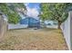 Large backyard with privacy fence, fire pit area, and mature trees, ideal for outdoor gatherings at 486 Sycamore Springs St, Debary, FL 32713