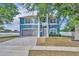Charming two-story blue home with a well-manicured lawn and brick paved driveway at 486 Sycamore Springs St, Debary, FL 32713