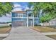 Charming two-story blue home with a well-manicured lawn and brick paved driveway at 486 Sycamore Springs St, Debary, FL 32713