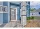 Close-up of front entrance features decorative glass door, landscaping, and brick walkway at 486 Sycamore Springs St, Debary, FL 32713