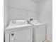 Practical laundry room featuring a washer, dryer, and storage shelf at 486 Sycamore Springs St, Debary, FL 32713