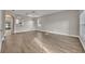 Spacious living room with light gray walls, wood flooring, and modern light fixture at 486 Sycamore Springs St, Debary, FL 32713