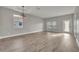 Bright living room featuring wood flooring, large windows, and glass panel back door at 486 Sycamore Springs St, Debary, FL 32713