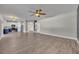 Spacious living room with wood floors that flows into an open-concept kitchen area at 486 Sycamore Springs St, Debary, FL 32713