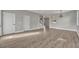 Spacious living room with light gray walls, wood flooring, staircase, and arched doorway at 486 Sycamore Springs St, Debary, FL 32713