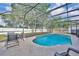 Sparkling screened-in pool with table and chairs offers a perfect spot for relaxation and dining at 486 Sycamore Springs St, Debary, FL 32713