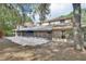 Large backyard with brick patio, screened-in porch, and mature trees providing ample shade at 5265 Myakka Rd, De Leon Springs, FL 32130