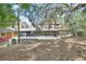 Expansive backyard showcasing a screened-in porch and a covered area, perfect for outdoor enjoyment and entertainment at 5265 Myakka Rd, De Leon Springs, FL 32130