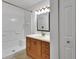 Bathroom featuring tiled shower and vanity with storage at 5265 Myakka Rd, De Leon Springs, FL 32130