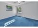 Bedroom with blue carpet and two windows that offer ample natural light at 5265 Myakka Rd, De Leon Springs, FL 32130