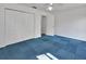 Bedroom with unique blue carpet and access to two closets at 5265 Myakka Rd, De Leon Springs, FL 32130