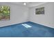 Bedroom with unique blue carpet and natural light from two windows at 5265 Myakka Rd, De Leon Springs, FL 32130