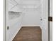 Walk-in closet with laminate flooring and ample shelving at 5265 Myakka Rd, De Leon Springs, FL 32130