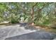 Long driveway leading to a secluded home, surrounded by lush greenery and mature trees at 5265 Myakka Rd, De Leon Springs, FL 32130