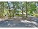Driveway winds through a forest-like setting, partially obscuring the residence at 5265 Myakka Rd, De Leon Springs, FL 32130