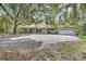 Sprawling home with brick exterior, porte-cochere, large driveway, and two-car garage at 5265 Myakka Rd, De Leon Springs, FL 32130