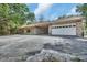 Spacious home exterior, showcasing a multi-car garage and covered front entrance at 5265 Myakka Rd, De Leon Springs, FL 32130
