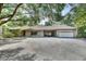 Brick house with covered carport and two-car garage situated on a sprawling property at 5265 Myakka Rd, De Leon Springs, FL 32130