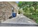 Side of home with driveway and trash bins at 5265 Myakka Rd, De Leon Springs, FL 32130