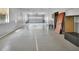 Large garage showcasing a roll-up door and tall ceiling for ample storage and parking at 5265 Myakka Rd, De Leon Springs, FL 32130
