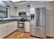 Bright kitchen featuring stainless steel appliances and tile flooring at 5265 Myakka Rd, De Leon Springs, FL 32130