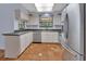 Bright kitchen featuring stainless steel appliances, undermount sink, and tile flooring at 5265 Myakka Rd, De Leon Springs, FL 32130